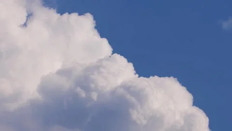 Realtime footage of a big white cloud against blue sky Stock Footage 278030769