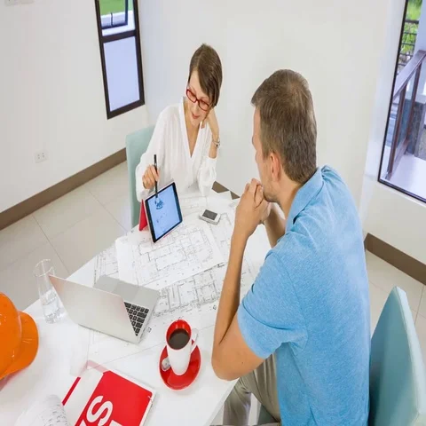 Realtor agent presenting a new project property on tablet pc for young customer Vídeo Stock 69513223