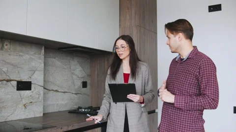 Realtor assists young man in exploring options for buying or renting a home Stock Footage 346224251