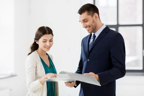 Realtor with folder showing documents to customer Stock Photos