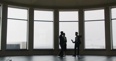 Realtor presenting modern office with panoramic windows to business Stock Footage 311284060