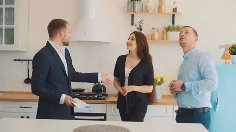 Realtor Shows the Kitchen Stock Footage 105931631