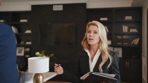 Realtor talking to a client at open house Stock Footage 101622179