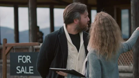 Realtor uses digital tablet computer to show plans of house Stock-Footage 262075247