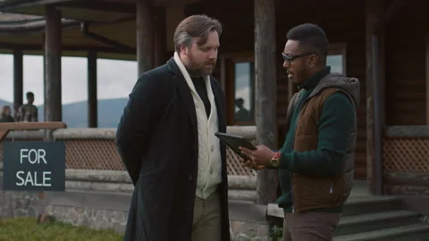 Realtor uses tablet computer to show plans of modern house Stock-Footage 262065549