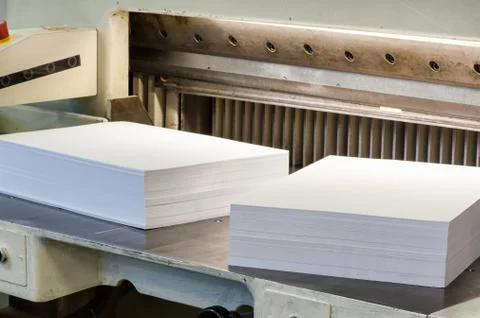 Reams of cut paper pages on a cutter machine Stock Photos