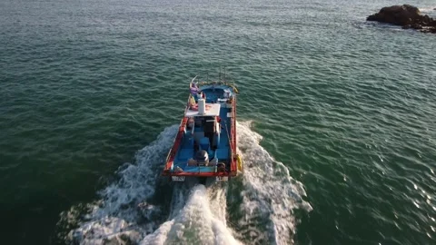 Rear aerial view of a small fishing boat in the morning in Ulsan, South Korea. Stock-Footage 236376653