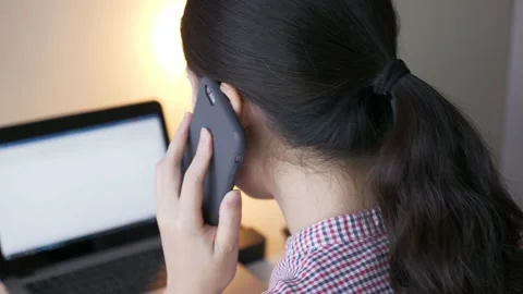 Rear angle, close up shot of young Asian woman discussing business on the phone Stock Footage 147112239