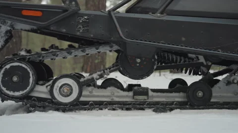 Rear ATV track and ski across snowy terrain. Serene scene of ATV rear track and Video stock 345145180
