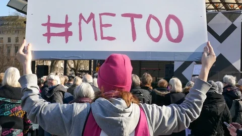 Rear back shot of a girl holding a #MeToo sign during demonstrations in Sweden Stock Footage