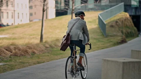 Rear back view businessman going to work on ebike. Eco friendly transport. Stock Footage 172522105
