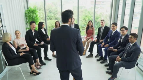 Rear back view of businessman standing at podium giving a speech addressing a Stock Footage 162181761