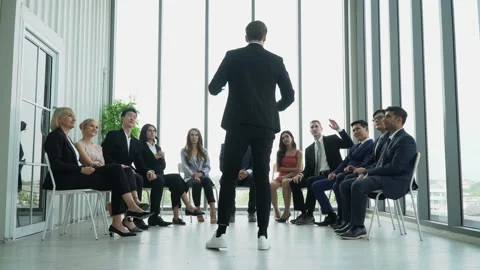 Rear back view of businessman standing giving a speech addressing a conferenc Stock Footage 162182031