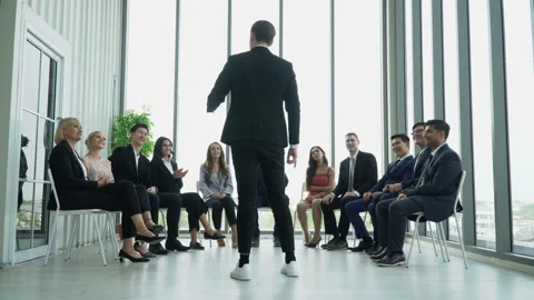 Rear back view of businessman standing giving a speech addressing a conferenc Stock Footage 162182327