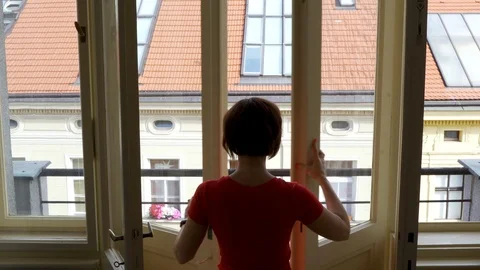 Rear back view at happy young woman opens doors and windows to balcony 스톡 동영상 119572338