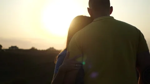Rear back view of young couple in love, hugging and holding hands against Stock Footage 135803949