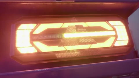 The rear brake light glows bright red on a new truck at the exhibition Stock Footage 333322166