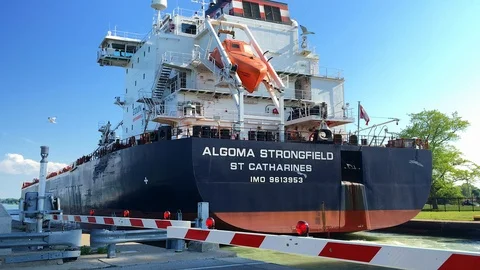 Rear of Cargo Ship Passing Through Welland Canal's Lock 1 (Seagulls Circling) Stock Footage 91635937