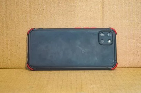 The rear casing of the smartphone has three cameras on a brown cardboard ba.. Stock Photos