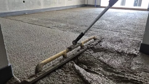Rear diagonal shot of smoothing polystyrene concrete in a room Stock Footage 343755756