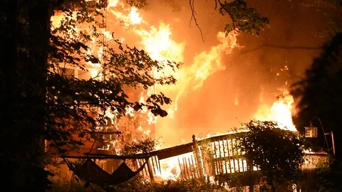 Rear Of A Home Engulfed in Flames Stock Footage 104375463