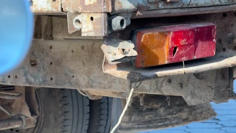 Rear light assembly and undercarriage of an old truck shake while the engine Stock Footage 337113274