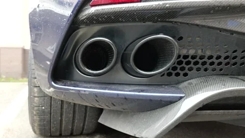 Rear lower bumper twin circular exhaust tips set within dark diffuser hexagonal Stock Footage 328211594
