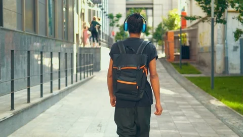 Rear man go with backpack in urban city Stock Footage 112946885