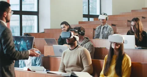 Rear of professor having speech in front of mixed-races students in VR glasses Video stock 234888905