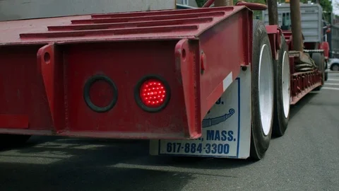 Rear Right Side View of a Flatbed Cargo Trailer Truck With Blinking Hazard Light Vídeo Stock 76768044