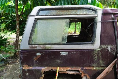 Rear section of abandoned rusty van with broken windows and peeling paint s.. Stock Photos