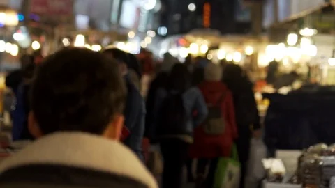 Rear shot of man walking down night food market in Seoul, South Korea 스톡 동영상 84757159