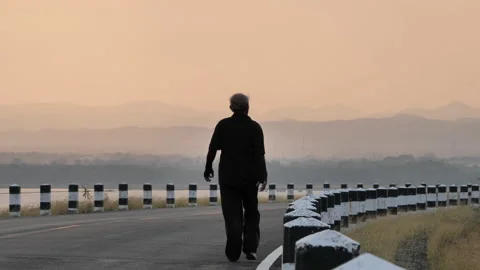 Rear view Asian elderly exercise. Senior man walking on road In the morning Stock Footage 138336360