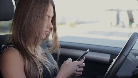Rear view of attractive young woman in business wear looking at her smartphone Stock Footage