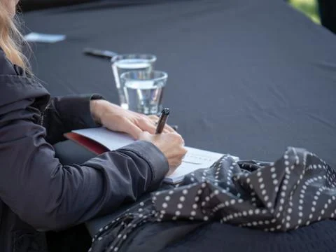 A rear view of author autographing book for fans Stock Photos