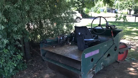 Rear view of Auto roller for lawns, machine is old and in bad condition, unkept Stock Footage 93658598