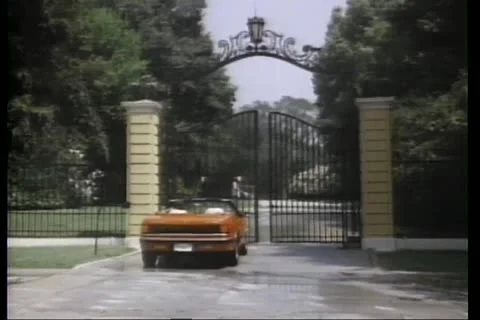Rear view automatic gate opening for a red convertible Stock Footage 11345654