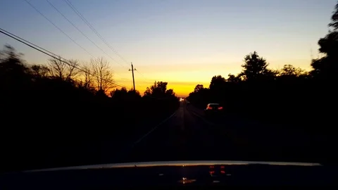 Rear View From Back of Car Driving Rural Road During Sunset or Sunrise Stock Footage 117869337