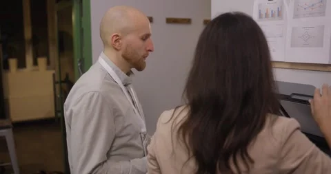 Rear view Bald man in a light gray shirt and a woman with long dark hair in Video stock 316371714