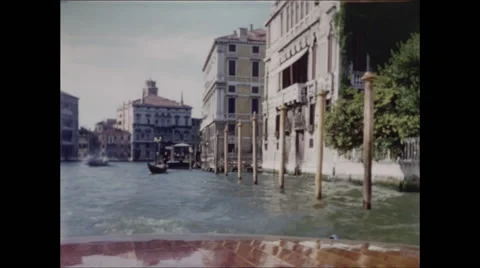Rear View from Boat Passing Posts in Canal Venice Italy 1957 Video stock 48075260