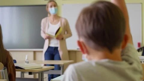 Rear view of boy volunteers for the answer. Stock-Footage 153607432