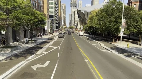 Rear view of bus driving down bustling street in downtown toronto, canada Stock Footage 302580684