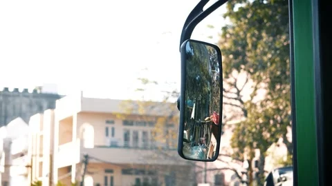 Rear View Bus Mirror Reflecting Busy Indian Road Traffic and City Movement Stock Footage 331145898