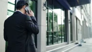 Rear View Businessman Using A Smartphone. Urban Lifestyle Concept. Stock Footage