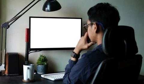 Rear view businessman working with computer in home office. Stock Photos