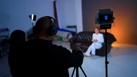 Rear view of the cameraman taking video in the studio. Stock Footage 333579093
