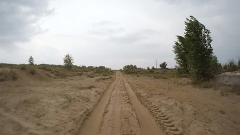 Rear view of car driving along a rural dirt road Stock Footage 74978073