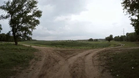 Rear view of car driving along a rural dirt road Stock Footage 76103293