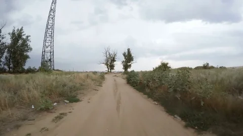 Rear view of car driving along a rural dirt road Stock Footage 78826314
