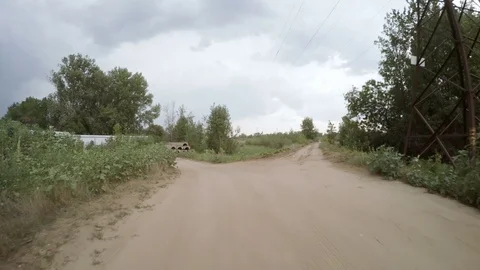 Rear view of car driving along a rural dirt road Stock Footage 79696699